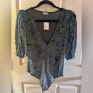 Super soft  Free People bodysuit. Has very cute shoulders